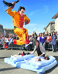 A man representing the devil and called Colacho jumps over young babies to ward off evil spirit in a village in Spain.