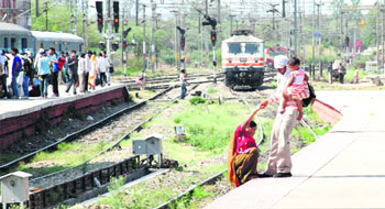 A man pulls up a woman from tracks minutes before a train arrives at the Chandigarh railway station.