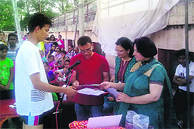 A winner of the state-level swimming championship receives a citation and an award in Haldwani on Tuesday