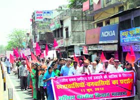 Forest dwellers holding a protest march against alleged state atrocities at Lalkuan under the banner of the Akhil Bharatiya Kisan Mahasabha on Monday