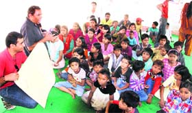 A workshop for slum children being organised on World Day Against Child Labour in Dehradun on Tuesday