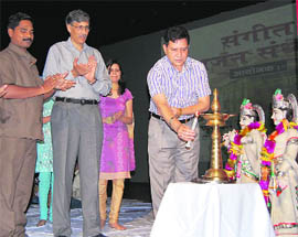 PL Thakur, IGP, lights the traditional lamp to inaugurate the bhajan sandhya at Dr RP Government Medical College in Tanda. 