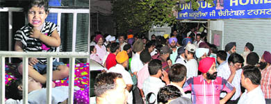 Residents gather outside Unique Home in Jalandhar and (left) a toddler at the shelter home distressed by the commotion outside. 