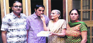 Abhishek's grand mother and parents celebrates his success in AIEEE exam.