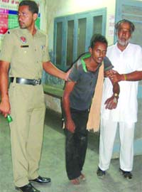 The accused being taken to a hospital for treatment in Shahkot on Tuesday