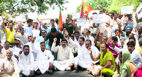 Activists of the BJP along with sarpanches and panches protest against the failure of the state government to delegate powers to panchayat members in Jammu on Tuesday.