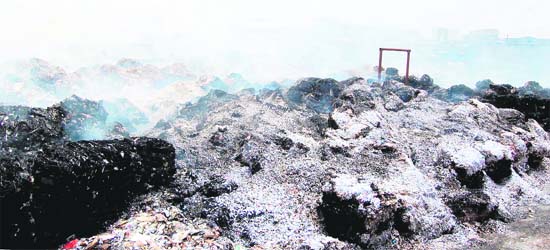 Raw material which was reduced to ashes in fire at Khanna Paper Mill in Amritsar