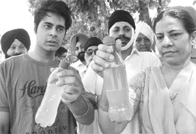 Residents of Phase 3 A show dirty potable water in Mohali on Wednesday.
