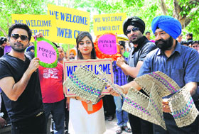 Jaspal Bhatti with artistes of his movie Power Cut distributes hand fans to make a satire on power crisis at Sector 17, Chandigarh, on Wednesday.