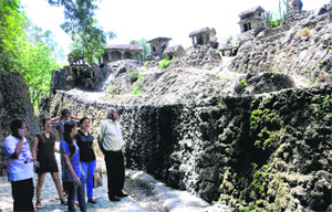 Creator of the Rock Garden Nek Chand (extreme right) looks at a waterfall which went dry after the pump set supplying water to it malfunctioned.
