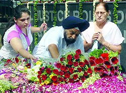 Relatives of the victims of Uphaar fire tragedy on its 15th anniversary paying floral tributes near the cinema in New Delhi on Wednesday