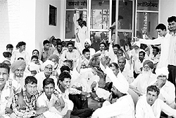 Villagers sit on a dharna against erratic power supply outside a powerhouse at Rania in Sirsa on Wednesday