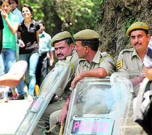 Policemen guard the Himachal Pradesh University campus after a clash between ABVP and SFI activists, in Shimla on Wednesday