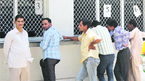 People stand outside the single window system at the deputy commissioners office in Jammu on Wednesday.