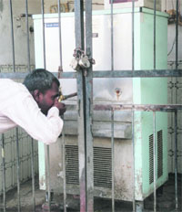 A commuter quenches his thirst from a water cooler in Jammu