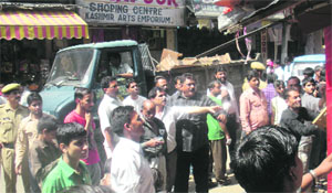 Shopkeepers remove goods from the main bazaar, Katra, after the MC launched an anti-encroachment drive on Wednesday evening. 