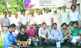 Participants pose for a group photograph during the five-day sculptors and painters camp at Bhagh-e-Bahu in Jammu on Wednesday.