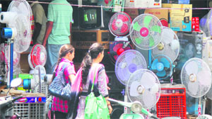 Air coolers and fans on display at a shop near Gumat Chowk in Jammu on Wednesday