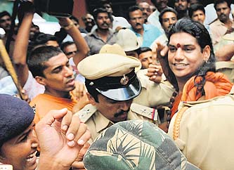 The police takes away Nithyananda after he surrendered before a magistrate at a court in Ramanagara, near Bangalore, on Wednesday.
