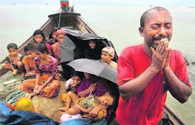A Rohingya Muslim, who fled Myanmar to Bangladesh to escape religious violence, pleads for help after he and others were intercepted by the Bangladesh border authorities in Taknaf on Wednesday