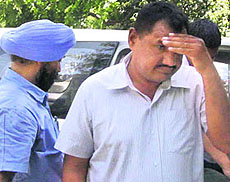 Constable Ram Niwas is taken to a court in Chandigarh on Thursday.