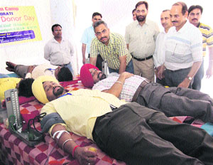 Volunteers donate blood on the World Blood Donor Day at Chandigarh on Thursday.