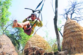 A child enjoys a swing ride at a village in Karnal