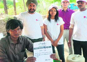 A labourer holds the oath form distributed by youth club members of E-Max Group of Institutions in Ambala