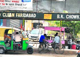 Street vendors and auto-rickshaws encroach upon the bus stop at BK Chowk in Faridabad