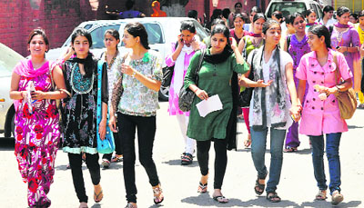 Girls come out of after appearing in the entrance test at Government Women College, Parade in Jammu on Thursday.