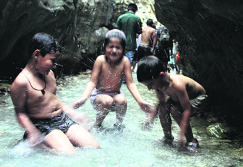 Children have a splash near Dehradun.