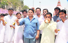Teerth Purohits hold a protest against power cuts by ringing bells and blowing a conch in Haridwar on Friday