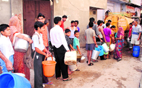 Residents of Darshan Bazar in Bhiwani await their turn for water from a tanker.