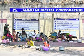 This rain shelter, outside the Jammu bus stand, has become home for these migrant families