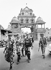 RAF jawans march in front of Jagannath Temple as part of preparations ahead of the Jagannath chariot procession starting on June 21, in Ahmedabad on Friday.