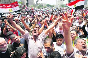 Protesters shout slogans against the Egyptian military council at Tahrir Square