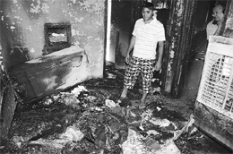 A resident looks at the remains after a fire broke out in a house at Phase 9 in Mohali on Saturday. 