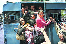 Protesting women government employees being arrested in Srinagar. 