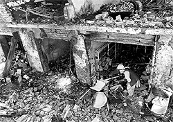 A security official inspects the site of a bomb explosion in the main bazaar of Landi Kotal in Pakistan