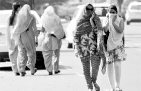 Girls cover themselves to escape the blistering sun at Phase VII in Mohali on Sunday.