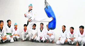 A student in action during the taekwondo summer coaching camp at Play Ways Senior Secondary School in Patiala on Sunday.