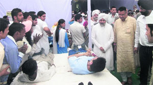 Baba Hardev Singh, spiritual head of the Nirankari Mission, along with local MLA Ganesh Joshi, inaugurates a blood donation camp in Mussoorie on Sunday. 