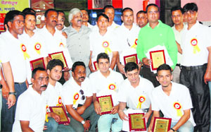 Members of the Uttarakhand Football Referees Association honour players and Sport Minister Dinesh Aggarwal in Dehradun on Sunday.