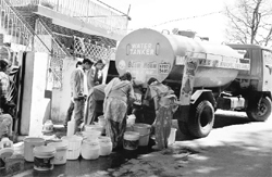 People queue up to get water from a tanker in Shimla on Sunday.