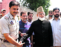 Chairman of the hardline faction of the Hurriyat Conference Syed Ali Shah Geelani being arrested by the police outside his Hyderpora residence in Srinagar on Sunday