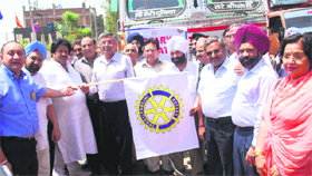 Minister for Relief, Revenue and Rehabilitation Raman Bhalla flags off trucks loaded with 700 desks for schools during a function organised by Rotary Foundation in Jammu on Sunday.