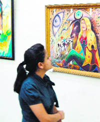A girl takes a look at the paintings during Summer Art Camp at the Indian Academy of Fine Arts in Amritsar. 
