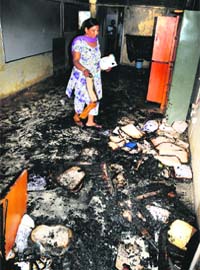A PGI employee looks for documents that were not destroyed in the fire at Research BlockB of the hospital in Chandigarh on Monday