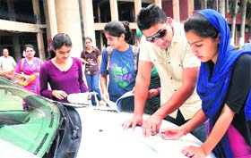 Students fill in admission forms on the first day of prospectus sale at the Government College For Girls, Sector 42, Chandigarh, on Monday