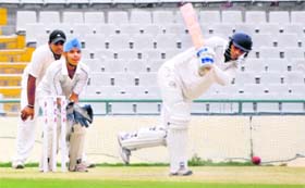 A batsman hits the ball during a match at the PCA Stadium in Mohali on Monday